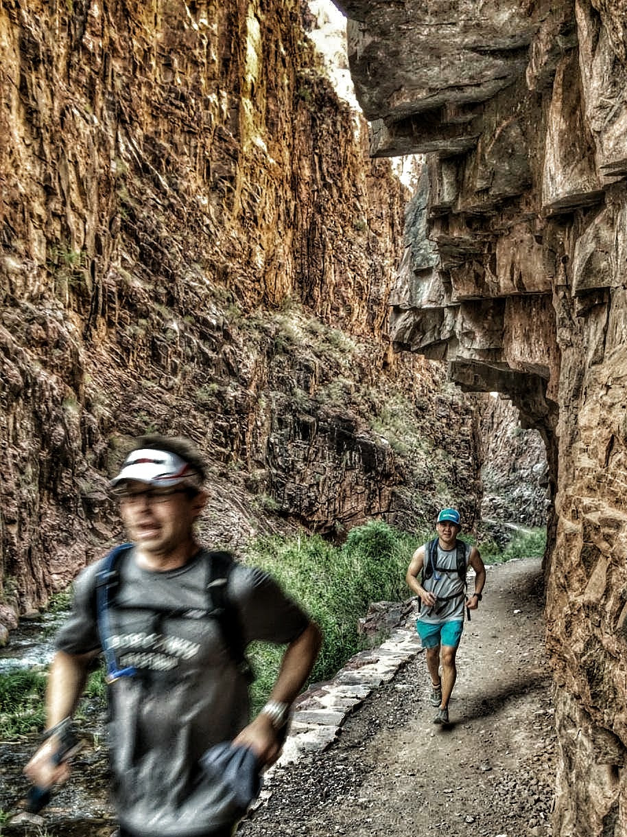 Two men running through the canyon