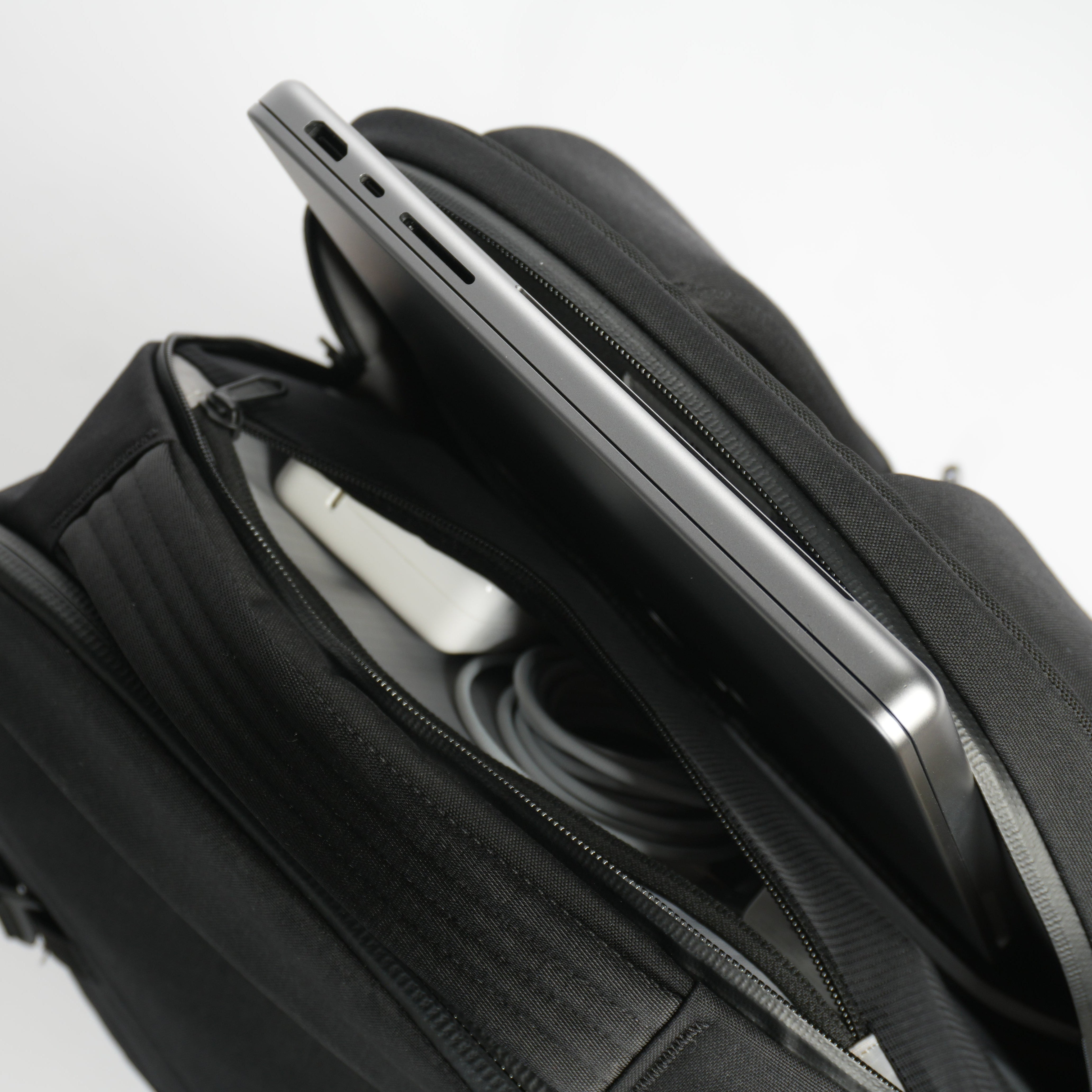 Laptop sitting in laptop pocket on DVRGE travel backpack 