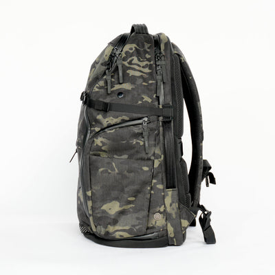 Side view of DVRGE X50 36L – Waterproof X-Pac® X50 Black Multicam® - LIMITED EDITION backpack on white background