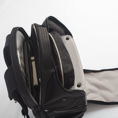 Upper zippers of DVRGE backpack opened to display laptop compartment and shelf divider 